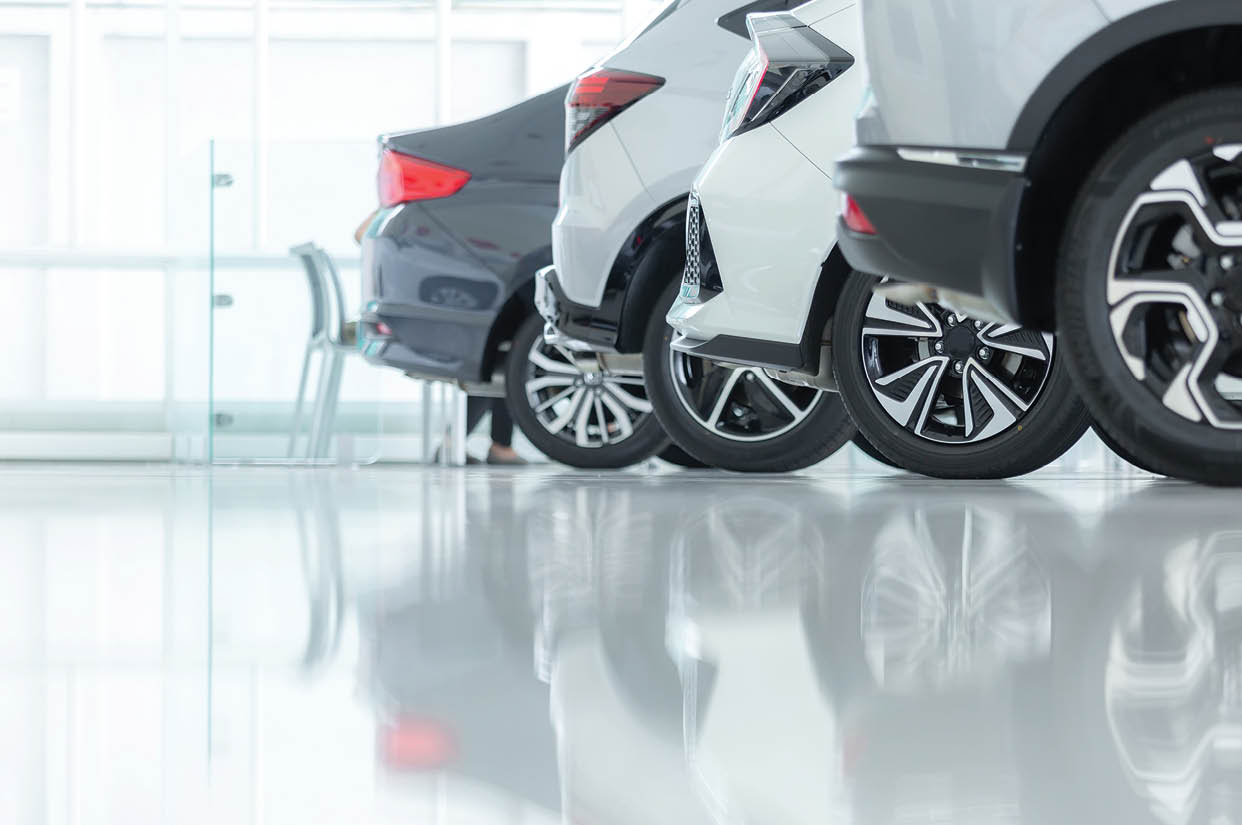 Cars For Sale, Automotive Industry, Cars Dealership Parking Lot. Rows of Brand New Vehicles Awaiting New Owners, on the epoxy floor in new car service