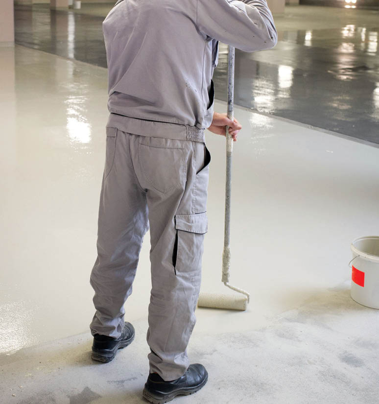 Manual worker putting non-slip layer on the floor